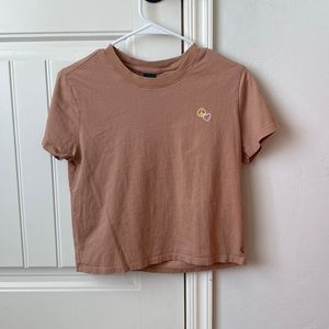 Tan cropped t shirt with a peace and heart sign. From wild fable in a small